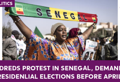 Image of protesters gathered in Senegal, holding signs and banners.