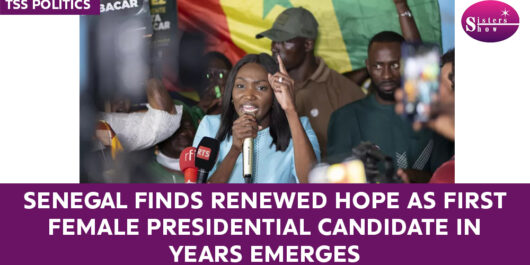 A woman speaking at a political rally, symbolizing hope and progress in Senegal